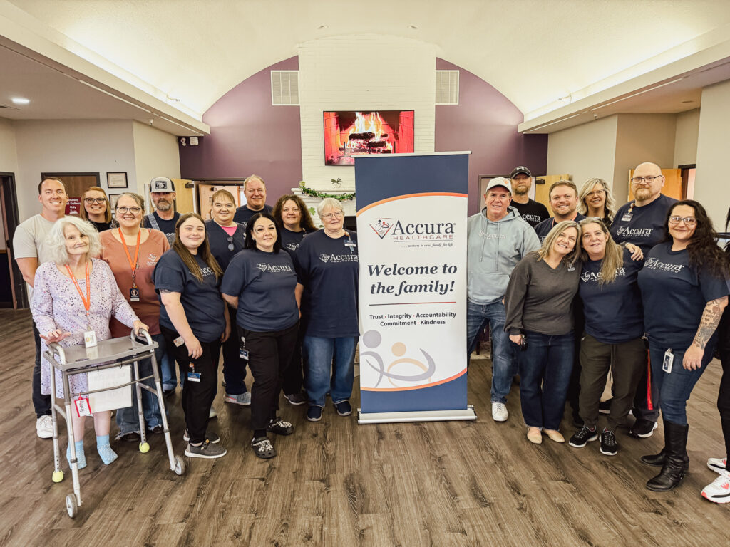 Group photo of Accura HealthCare leadership, staff, and residents at Welcome to the Family event