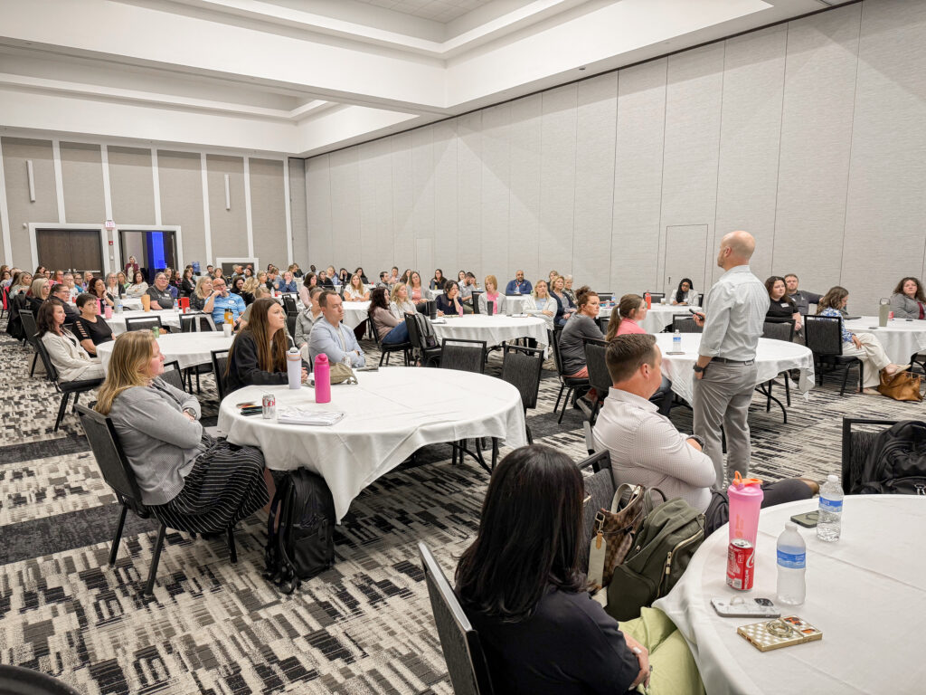 Accura HealthCare leaders and team members gathered during a presentation at the 2026 Annual Meeting and Awards Banquet.