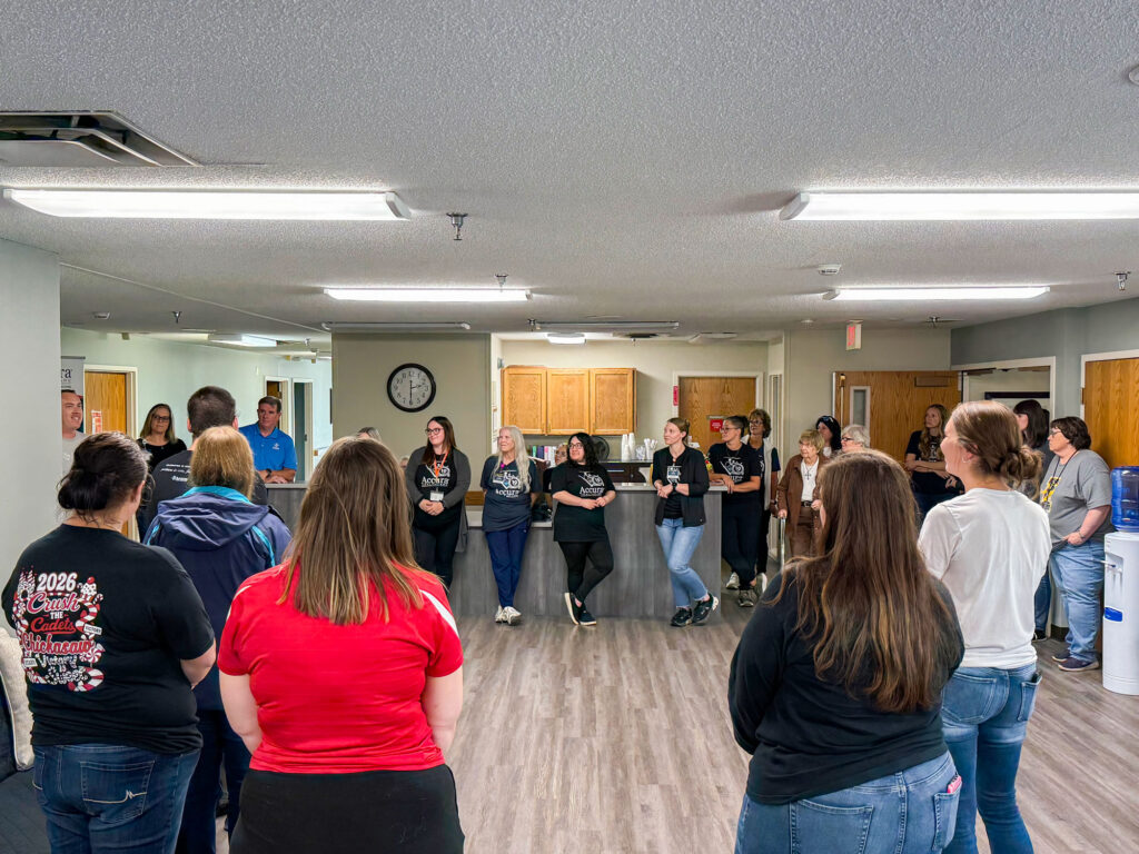 Accura HealthCare team member speaks with team members and guests during the grand reopening celebration at Accura HealthCare of New Hampton
