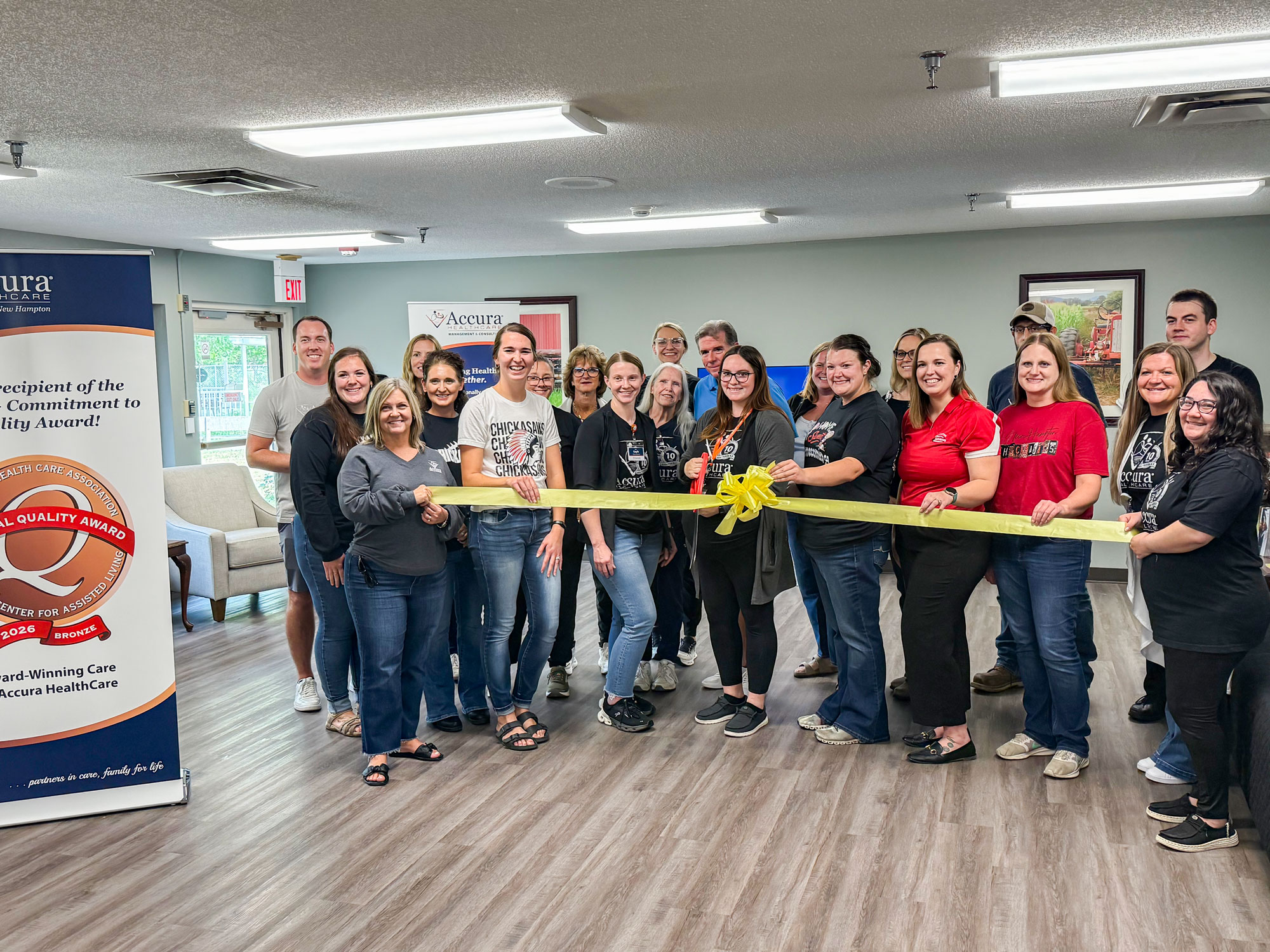 Accura HealthCare of New Hampton team members participate in a ribbon cutting ceremony celebrating the community’s grand reopening